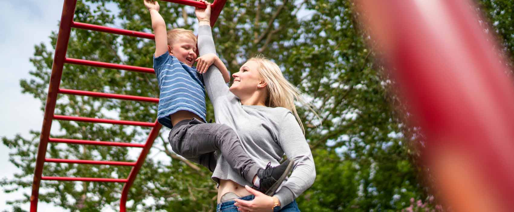 mom with son at playground wearing ostomy bag